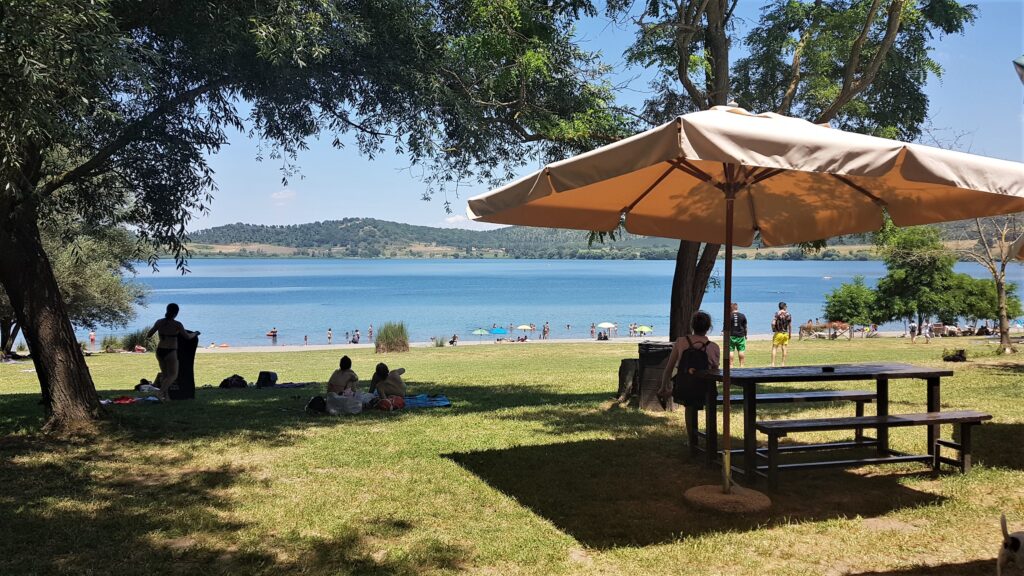 foto del lago di Martignano, con un’area picnic in primo piano.